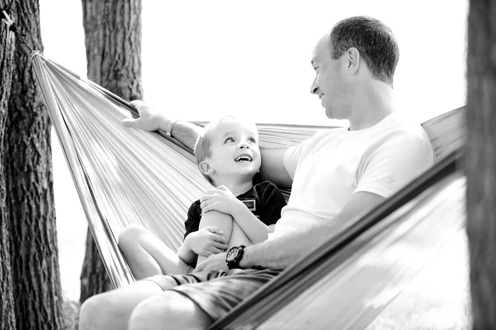 father and son in double hammock