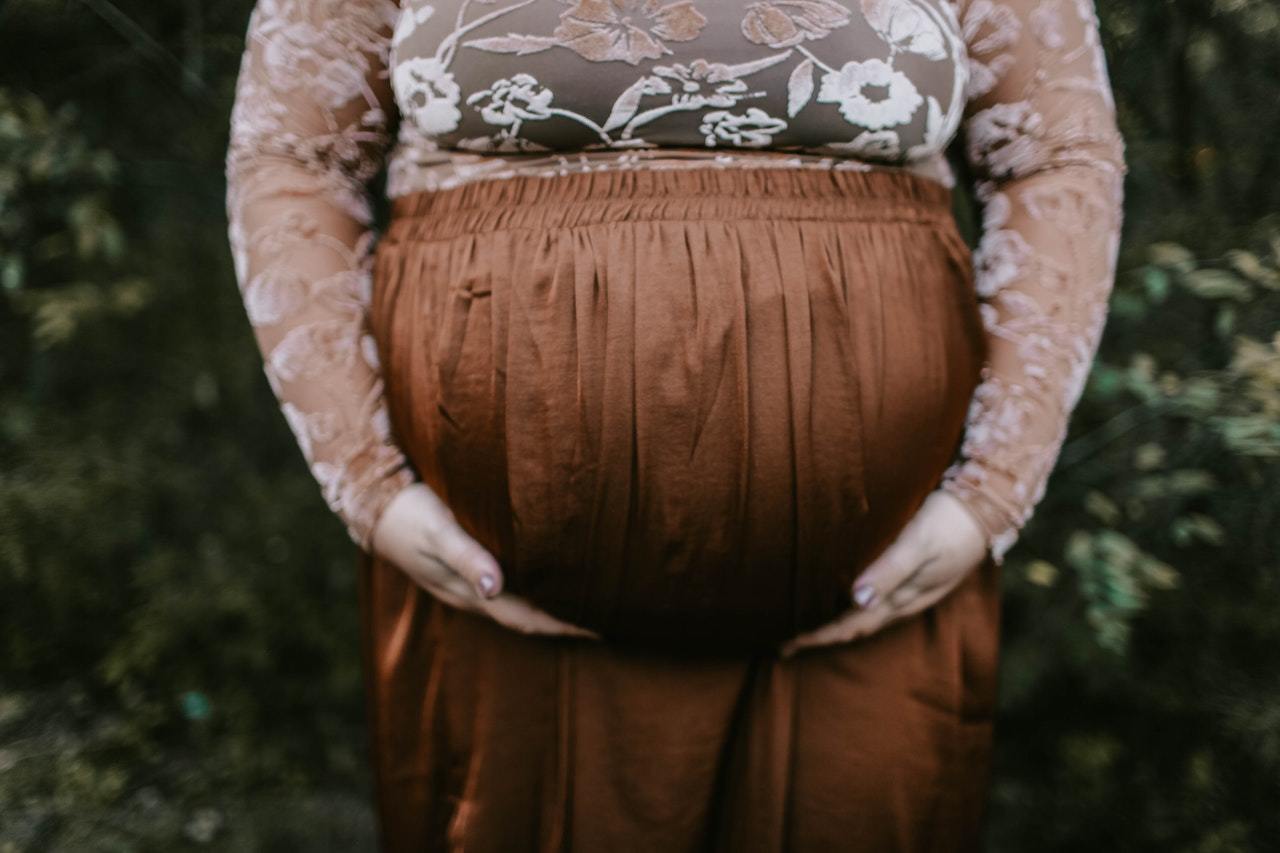 lady holding pregnant stomach