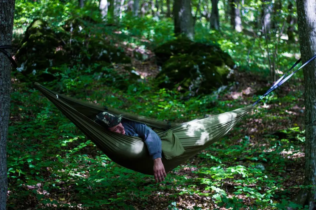 man asleep in hammock